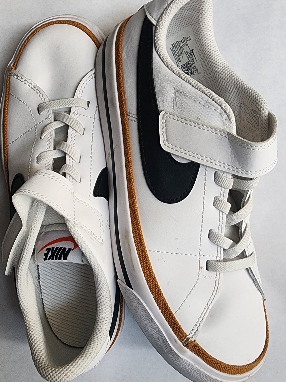 Nike Kids White Sneakers with Black Swoosh and Brown Trim